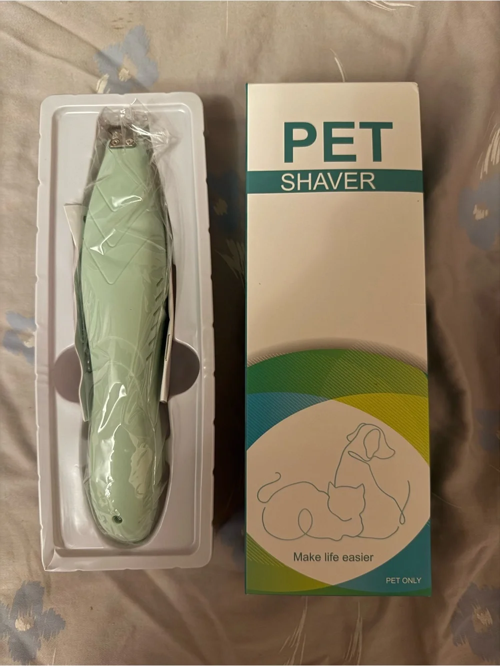 This a green electric pet shaver designed for trimming hair on dogs and cats.